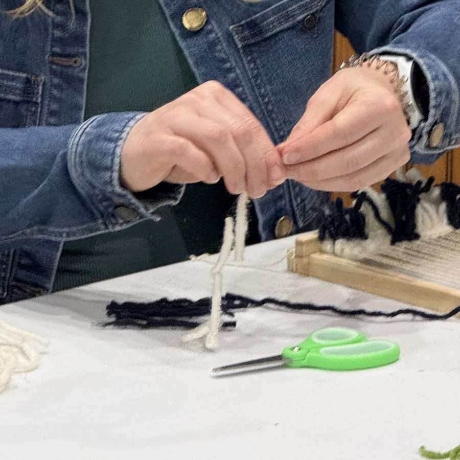 Hands weaving with Moroccan yarn